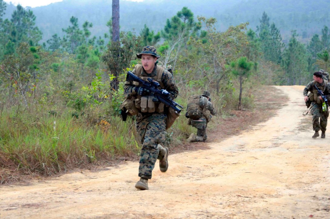 Cpl. Gabriel Rubin, ground combat element, and fellow Marines from Security Cooperation Task Force (SCTF), participate in a jungle survival information exchange at Pine Ridge Forest Reserve with the Belize defense force, Feb. 27. SCTF is deployed to the U.S. Southern Command (USSOUTHCOM) area of responsibility supporting Amphibious Southern Partnership Station 2011 (A-SPS 11), providing opportunities for participating nations to come together and join efforts to enhance regional maritime security. (U.S. Navy photo by Mass Communication Specialist 1st Class Brian S. Finney)