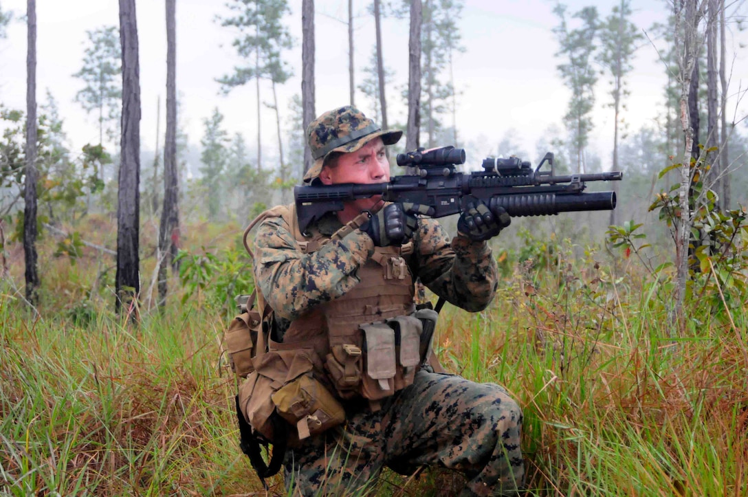 Cpl. Gabriel Rubin, ground combat element, Security Cooperation Task Force (SCTF), participates in a jungle survival information exchange at Pine Ridge Forest Reserve with the Belize defense force, Feb. 27. SCTF is deployed to the U.S. Southern Command (USSOUTHCOM) area of responsibility supporting Amphibious Southern Partnership Station 2011 (A-SPS 11), providing opportunities for participating nations to come together and join efforts to enhance regional maritime security. (U.S. Navy photo by Mass Communication Specialist 1st Class Brian S. Finney)