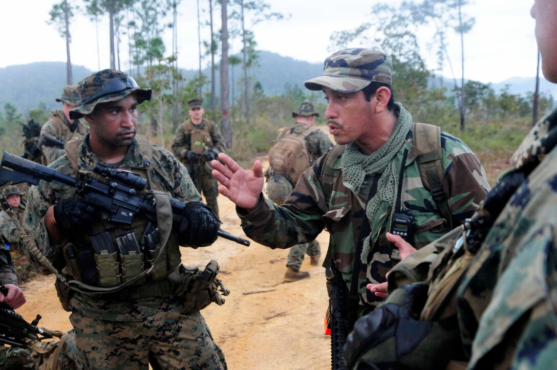 Belizean Sgt. Elisha Novelo, jungle warfare instructor, gives guidance to U.S. Marines from Security Cooperation Task Force (SCTF) during a jungle survival information exchange at Pine Ridge Forest Reserve, Feb. 27. SCTF is deployed to the U.S. Southern Command (USSOUTHCOM) area of responsibility supporting Amphibious Southern Partnership Station 2011 (A-SPS 11), providing opportunities for participating nations to come together and join efforts to enhance regional maritime security. (U.S. Navy photo by Mass Communication Specialist 1st Class Brian S. Finney)::r::::n::