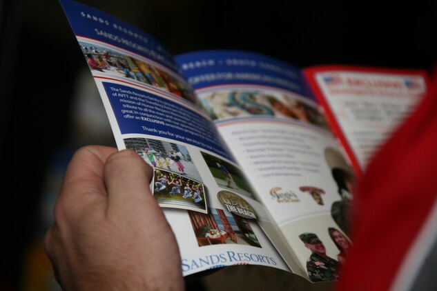 A patron of the 10th annual Travel Expo looks at a brochure for one of the vendors of the event hosted by the Information, Ticket and Travel office at Miller’s Landing Feb. 27. There were 27 establishments represented at the expo to include Universal Studios, Medieval Times and SunCruz Aquasino. “This expo gives a lot of great information to the families to help them plan out their trips,” said Matt P. Balek, a visitor to the ITT Travel Expo. “My family and I have been to this event on multiple occasions and used the information we received to plan out a great family vacation.”