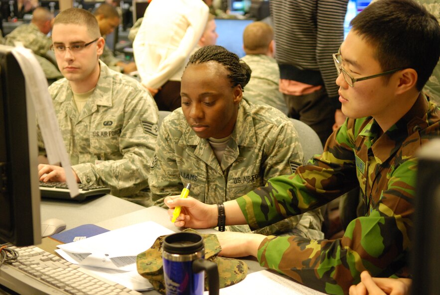 Staff Sgt. Hwang Song Hun, Republic of Korea forces air simulation specialist, works with Staff Sgts. Muneerah Williams and Michael Rowe, U.S. Air Force air operators from Kunsan Air Base, to prepare for exercise Key Resolve Feb. 24, 2011, at Osan Air Base, South Korea.