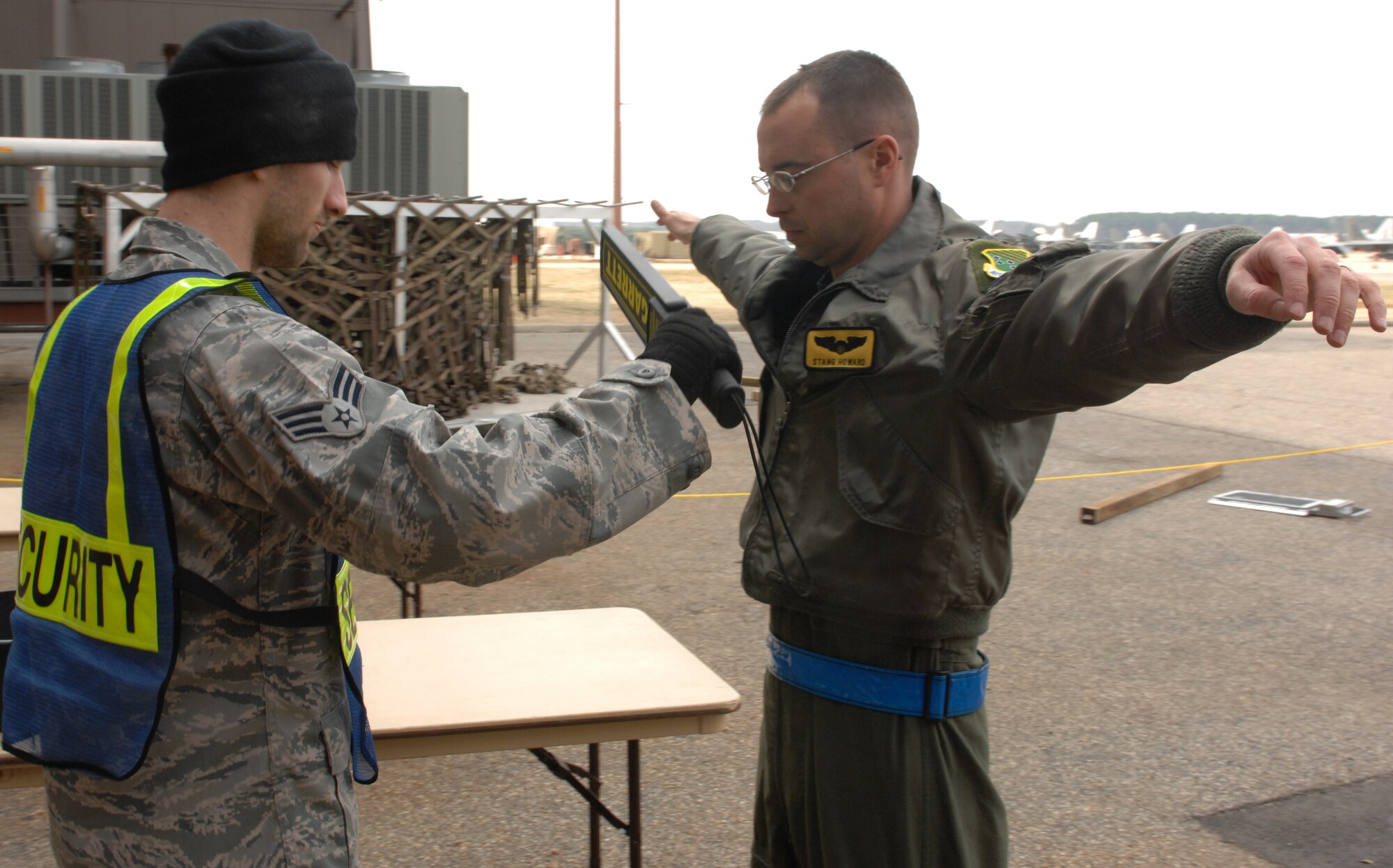 Senior Airman Christopher Caplinger, 633d Force Support  Squadron air passenger transit security personnel, screens Captain Matt Howard 27th Fighter Squadron pilot, before entering the personnel deployment function line during an Operation Readiness Exercise at Langley Air Force Base, Va, Feb. 27, 2011. Langley Airman took part in an operational readiness exercise to test their ability to resiliently deploy short notice. (U.S. Air Force photo by Senior Airman Antoinette Gibson/Released)