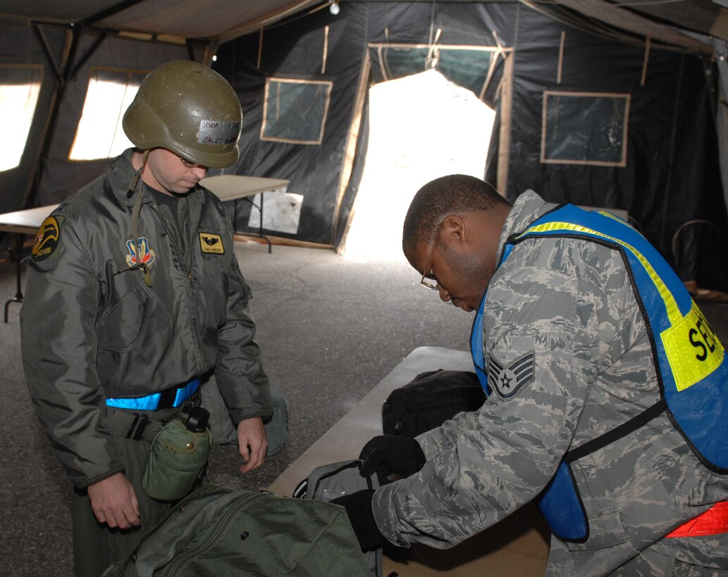 Staff Sgt. Ricky Shellman, 633d Force Support Squadron NCOIC of manning control, inspects Capt. Matt Howard, 27th Fighter Squadron pilots’ mobility bag in the holding tent during an Operation Readiness Exercise at Langley Air Force Base, Va, Feb. 27, 2011. The 1st Fighter Wing, 633d Air Base Wing, and 192d Fighter Wing participated in a two-day ORE to test the base readiness in case of a disaster, imminent terrorist or enemy threat and short-notice orders to deploy. (U.S. Air Force photo by Senior Airman Antoinette Gibson/Released)