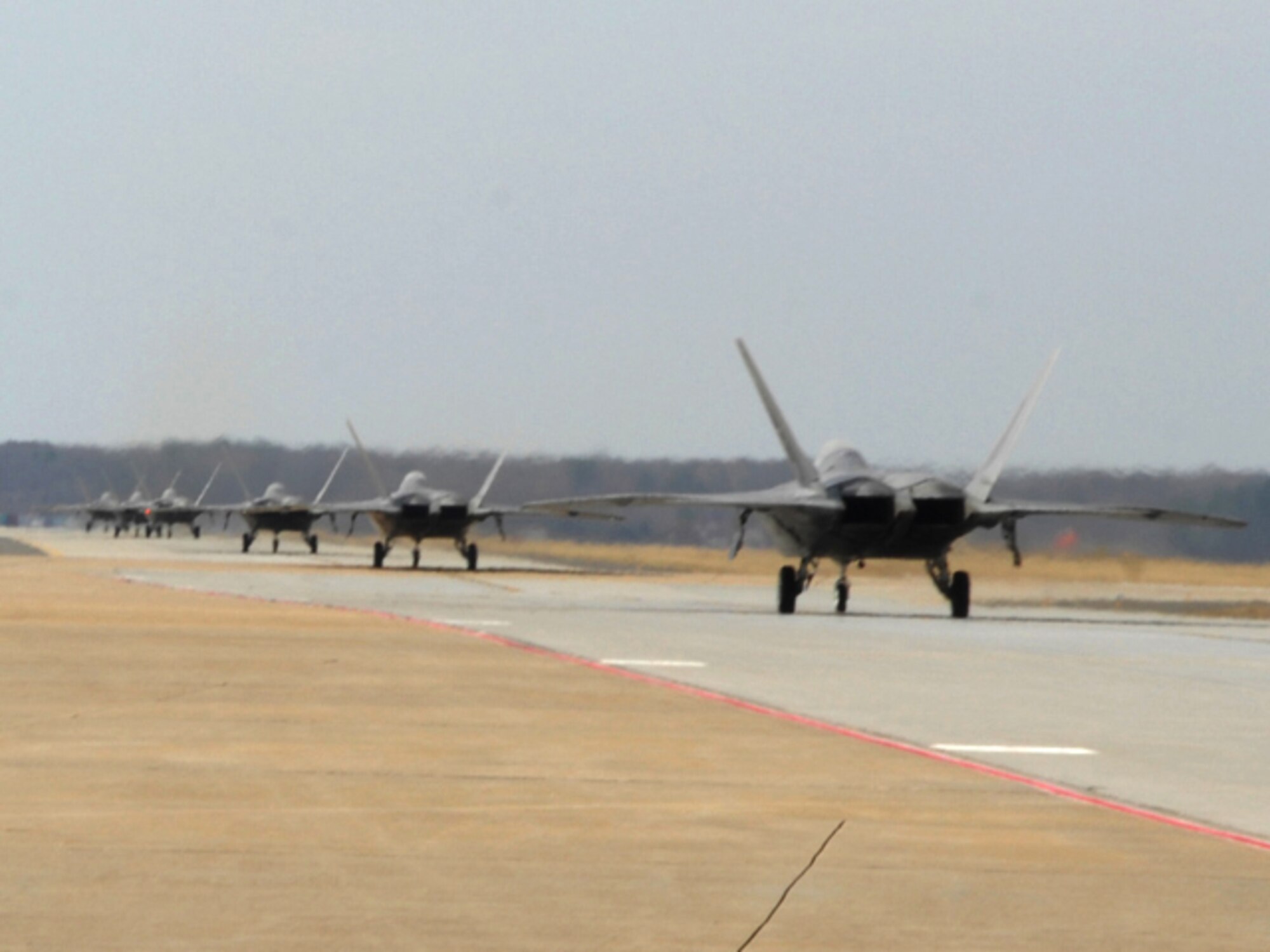 F-22A Raptors Taxi down the runway to base X during an Operational Readiness
Exercise at Langley Air Force Base, Va., Feb. 27, 2011. The exercise is a
two-day long evaluation of Langley Airmen from the 633d Air Base Wing, 1st
Fighter Wing and 192nd Fighter Wing worked together to practice deploying
people, equipment and aircraft for contingency operations on a moment's
notice.(U.S. Air Force photo by Airman 1st Class Camilla Elizeu/Released)  

 
