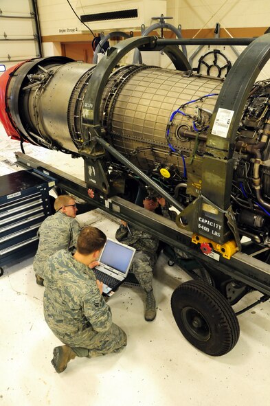 Airman1st Class Matthew McEwen, Senior Airman John Broberg and Airman 1st Class Alicia Jenness conduct repairs on a dismantled F-16 Block 50 engine.  The engine repairs were being completed at the 148th Fighter Wing in Duluth Minn. Feb. 26, 2011.  (U.S. Air Force photo by Staff Sgt. Donald Acton/released)