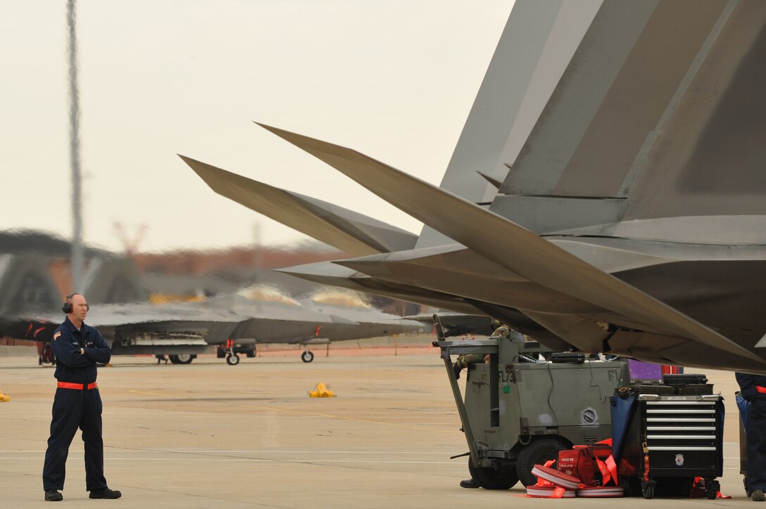Staff Sgt. Hugh Price, 94th Aircraft Maintenance Unit F-22A Raptor crew chief inspects an F-22 prior to flight at Langley Air Force Base, Va, Feb. 27, 2011. Langley Airmen from the 633d Air Base Wing, 1st Fighter Wing and 192nd Fighter Wing worked together to practice deploying people, equipment and aircraft for contingency operations on short notice. (U.S. Air Force photo by Staff Sgt. Logan Tuttle/Released)