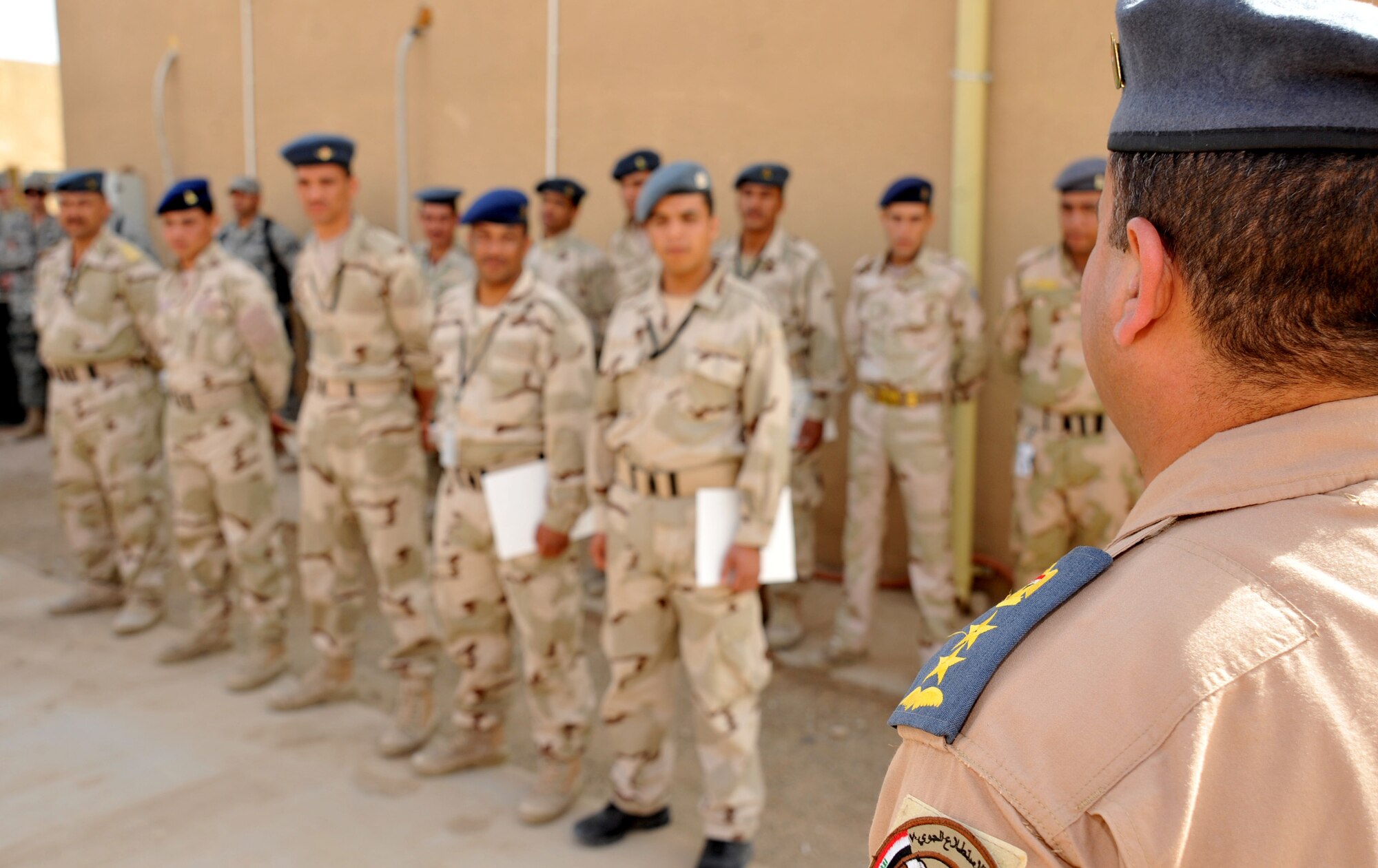 An Iraqi Air Force colonel speaks to the first group of Iraqi defenders during a graduation ceremony Feb. 22, 2011, at Ali Air Base, Iraq. The Iraqi airmen completed two weeks of security forces training, including written and practical exams, held by Iraq Training and Advisory Mission – Air advisors and members of the 407th Expeditionary Security Forces Flight. (U.S. Air Force photo by Senior Airman Andrew Lee/Released)