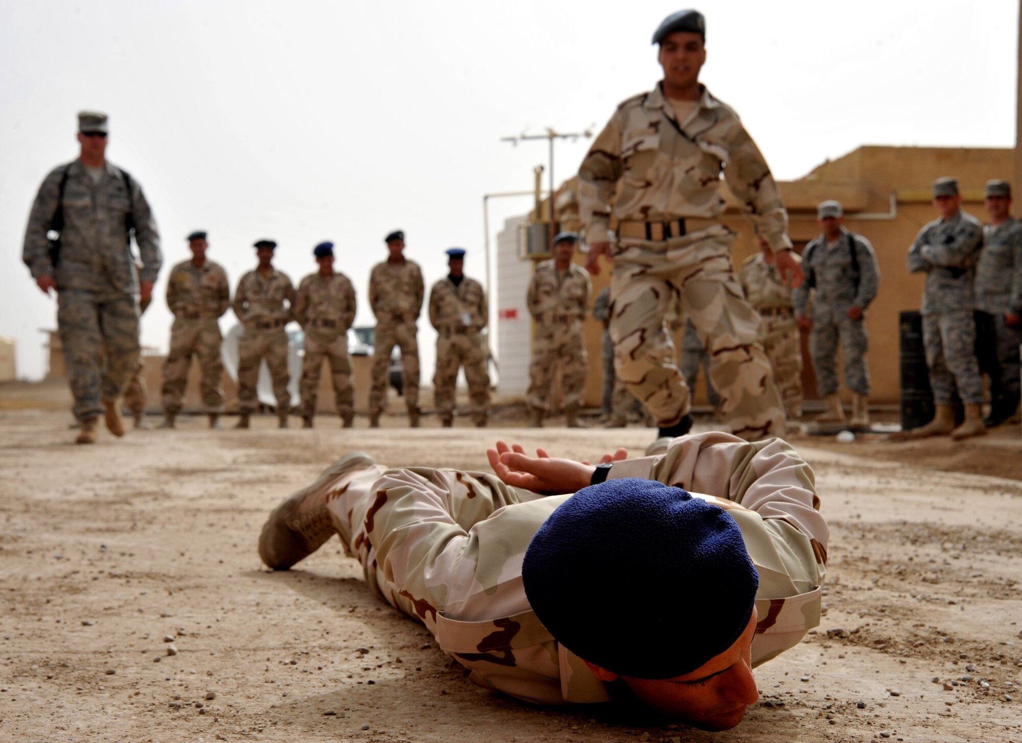 An Iraqi air force airman runs to apprehend a fellow classmate during a security forces training session held by Iraq Training and Advisory Mission – Air advisors and members of the 407th Expeditionary Security Forces Flight Feb. 21, 2011, at Ali Air Base, Iraq.  (U.S. Air Force photo by Senior Airman Andrew Lee/Released) 