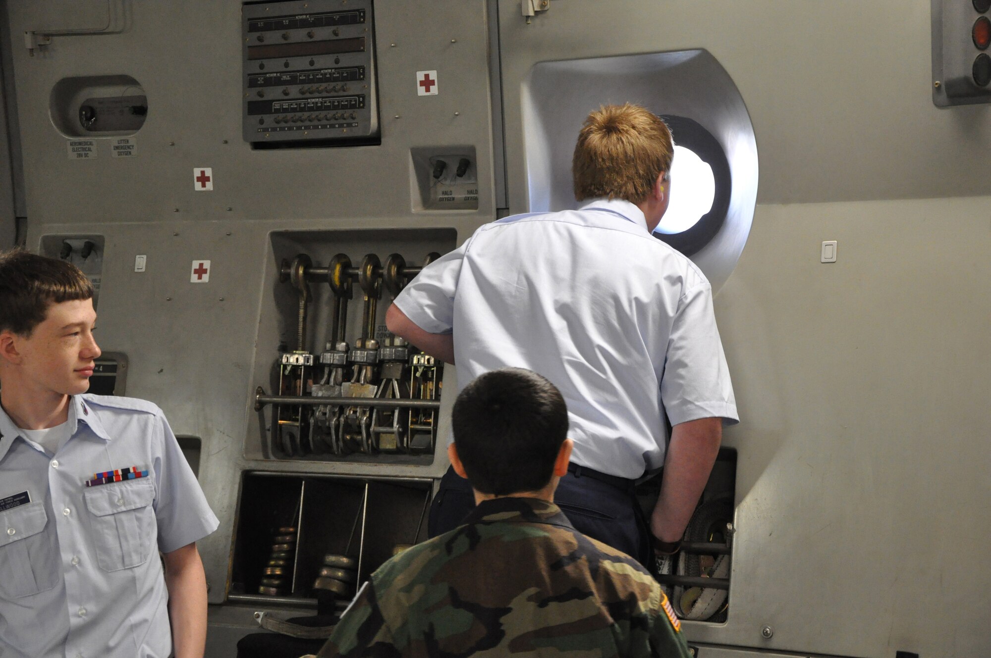 Cadets from the South Carolina Civil Air Patrol view the flightline from a window of a C17 Globemaster III aricraft at Joint Base Charleston, S.C. prior to takeoff for an orientation flight with the 315th Airlift Wing here Feb. 26, 2011. (U.S. Air Force Photo/Senior Airman Robert Pilch)