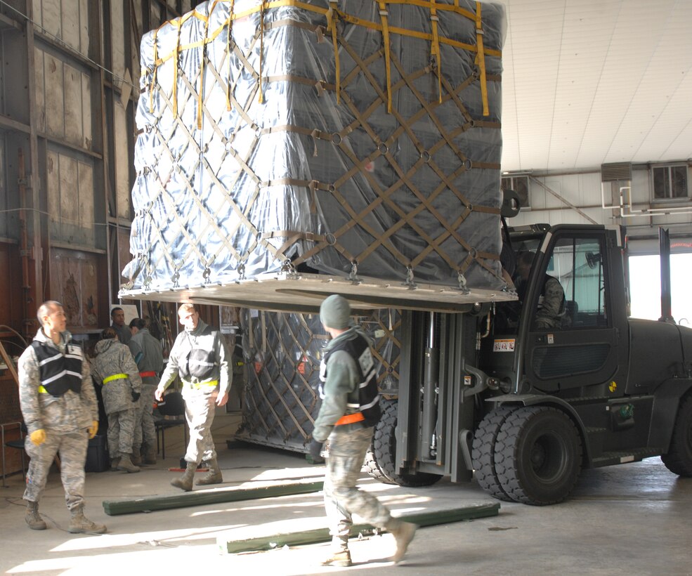Cargo movement team Airmen inspect pallets for corrosion during a two-day exercise at Langley Air Force Base, Va Feb. 26,2011. This movement team was in charge of weighing and inspecting cargo to ensure it met the standards before simulating loading it on an aircraft. (U.S. Air Force photo by Senior Airman Antoinette Gibson/Released)