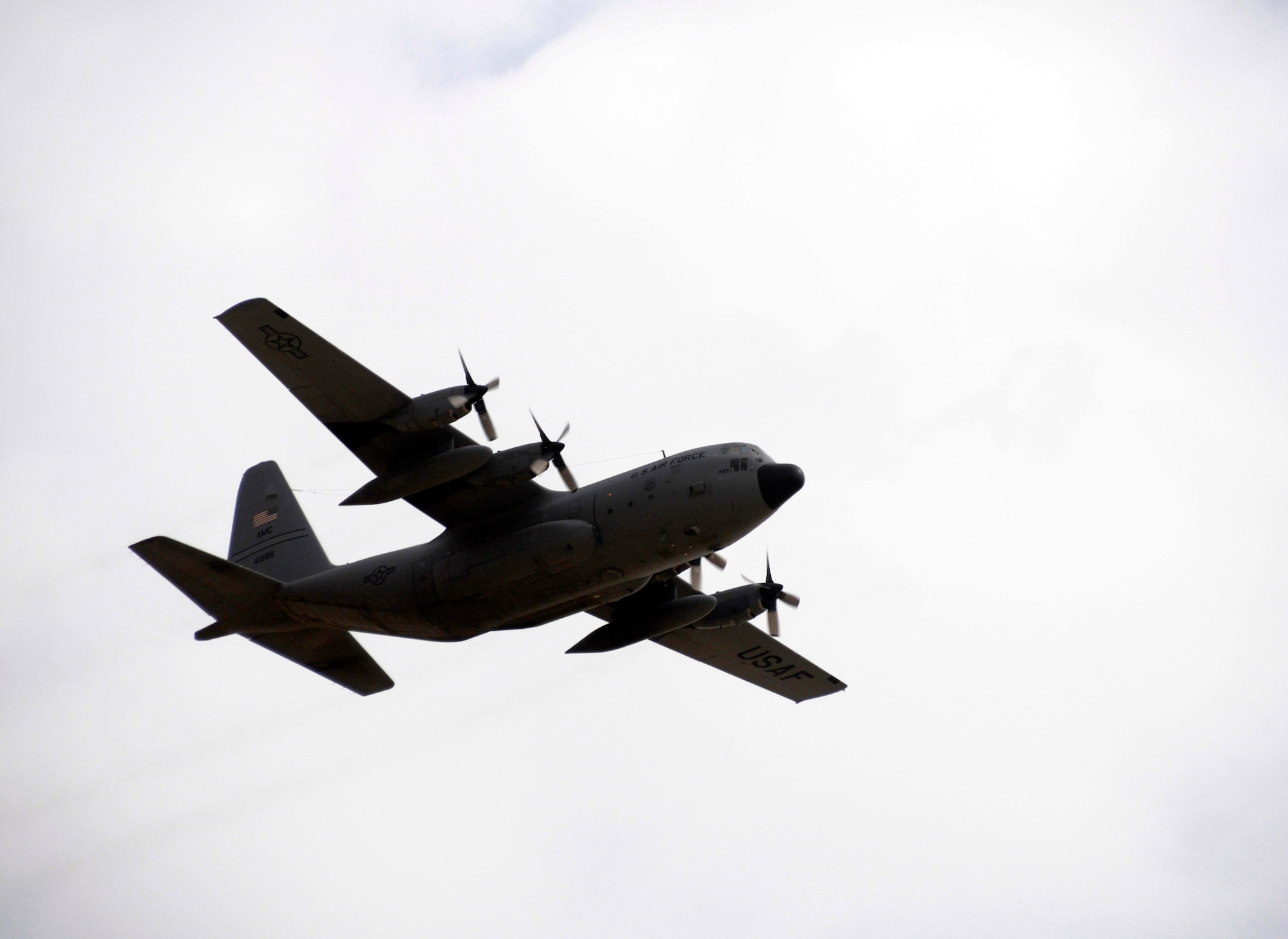 A 386th Air Expeditionary Wing C-130H Hercules, piloted by Maj. Tim Townsend, conducts a flyby in Kuwait for the nation's 50/20 celebration, which commemorates the 50th anniversary of its liberation from Great Britain and 20th anniversary of its liberation from Iraq. (U.S. Air Force photo by Capt. Heath Allen)