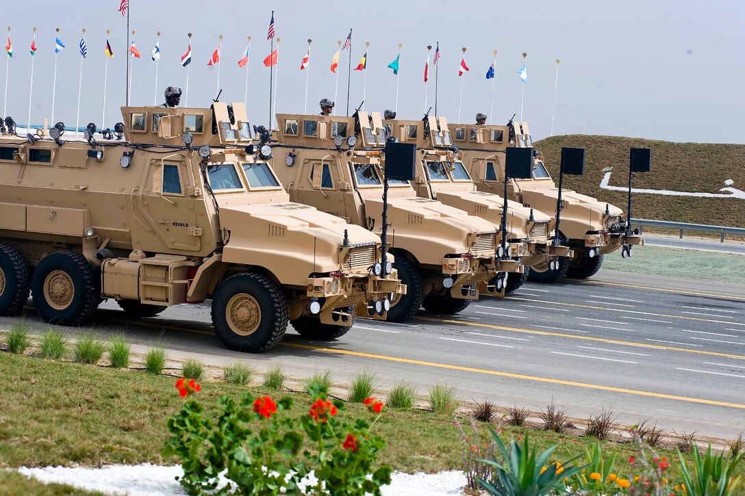 U.S. Army Caiman vehicles make a pass and review on the parade grounds as part of the 50/20 Celebration parade in Kuwait, Feb. 26, 2011. U.S. forces, along with troops from multiple nations were invited to Kuwait to take part in Kuwait’s 50/20 Celebration, honoring 50 years of Kuwait’s independence and the 20 years of liberation. Kuwait and the U.S. have shared a strong relationship since Operation Desert Storm and continue to build upon an enduring partnership between nations.