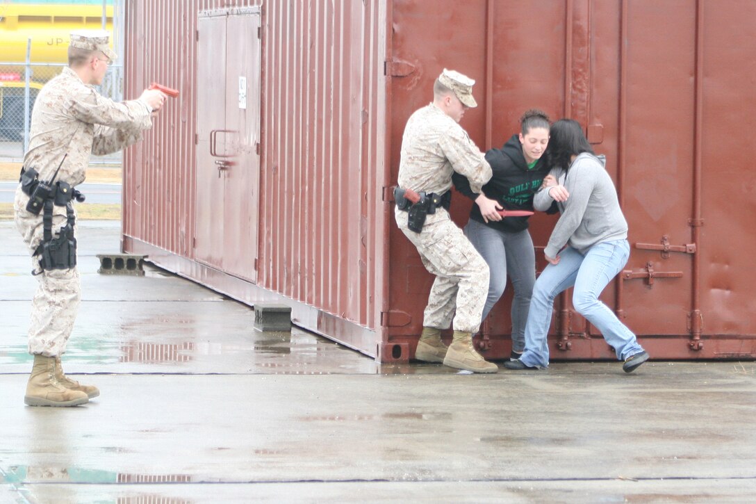 Provost Marshal’s Office Marines apprehend a hostage-taking fence-jumper as part of a suspicious person scenario during Active Shield 2011 here Feb. 28. Intelligence reports had already increased awareness on station; however, intelligence gathered on the suspicious person confirmed an imminent threat to military installations and officially kicked off Active Shield 2011.