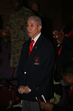 Retired Master Sgt. Johnnie Thompkins, 83, stands as he is honored for his service during Montford Point Marines Association Incorporated’s lecture of the history of the Montford Point Marines to bring Black History Month to a close at the Cherry Point theater Feb. 28. Thompkins is one of the 20,000 Marines to conduct their training at Montford Point between 1942-1949.