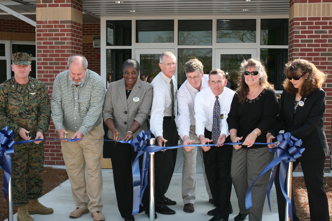 Key personnel involved in the construction cut the ribbon in front of the new Child Development Center aboard Cherry Point Feb. 28. The $5.2 million high-tech facility will play host to 96 children and 52 child care providers.