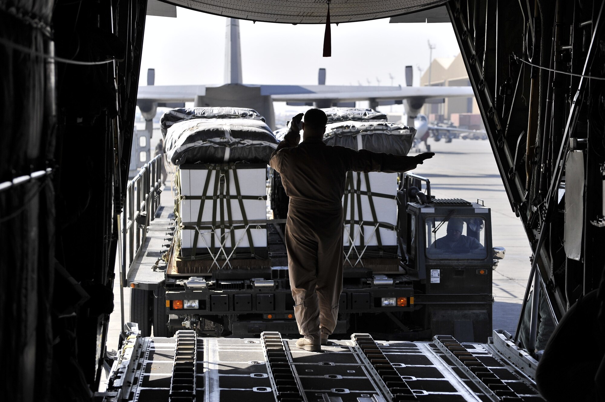 Members from the 455th Expeditionary Aerial Port Squadron unload cargo from a C-130 Hercules at Bagram Airfield, Afghanistan, Feb. 27, 2011.  The 455th EAPS was recently named the Air Combat Command’s winner of the 2011 Verne Orr Award. (Air Force photo by Capt. Erick Saks)