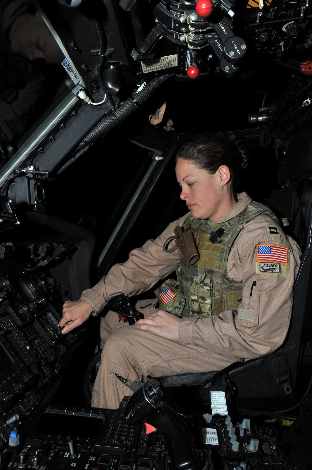 Capt. Marisa Catlin, 83rd Expeditionary Rescue Squadron HH-60G Pave Hawk pilot, conducts a pre-flight check at Bagram Airfield, Afghanistan. Captain Catlin is deployed from the 48th Fighter Wing; Royal Air Force Lakenheath; United Kingdom. (Air Force photo by Senior Airman Sheila deVera)