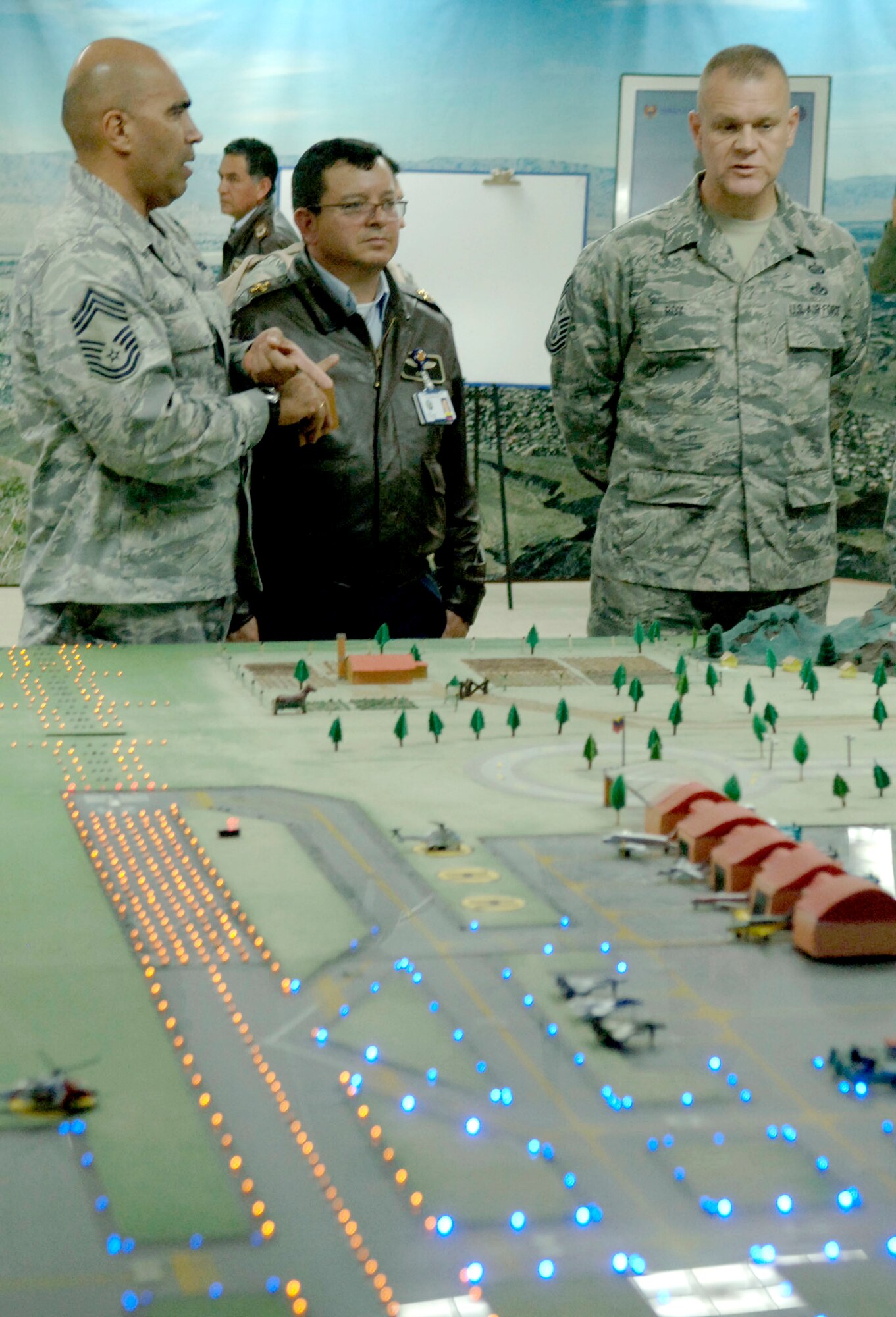 Chief Master Sgt. Andres Alvarez (left), an Inter-American Air Force Academy command chief, translates for Chief Master Sgt. of the Air Force James A. Roy (right) during a discussion with Colombian Col. Cano, the commander of the Colombian air force Escuela de Suboficiales Feb. 1, 2011, in Bogota. The Escuela de Suboficiales is a three-year NCO academy which grants undergraduate degrees in military specialties to more than 100 students per year. (U.S. Air Force photo/Tech. Sgt. Eric Petosky) 