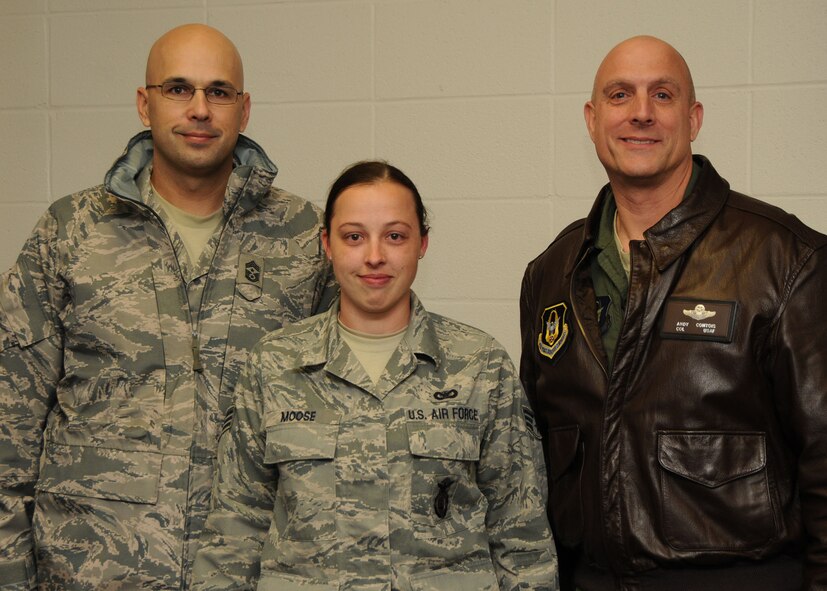 Senior Airman Delania Moose, 919th Security Forces Squadron, poses for a photo with Chief Master Sgt. Michael Klausutis, 919th Special Operations WIng command chief, left, and Col. Andy Comtois, 919th SOW commander, after they informed her of her selection as the wing's 2010 Airman of the Year.  The senior leaders traveled to four different work centers to surprise the winners of the Airman, NCO, senior NCO and first sergeant categories. (U.S. Air Force photo/Tech. Sgt. Samuel King Jr.)