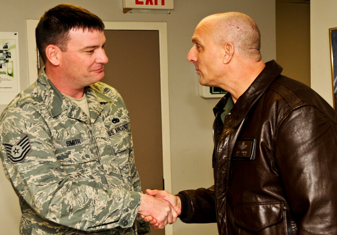 Technical Sgt. Kelly Smith, 919th Aircraft Maintenance Squadron, left, receives congratulations from Col. Andy Comtois, 919th Special Operations Wing commander, for being selected as the wing's 2010 NCO of the Year.   The colonel and his command chief traveled to four different work centers to surrprise the winners of the Airman, NCO, senior NCO and first sergeant categories. (U.S. Air Force photo/Tech. Sgt. Samuel King Jr.)