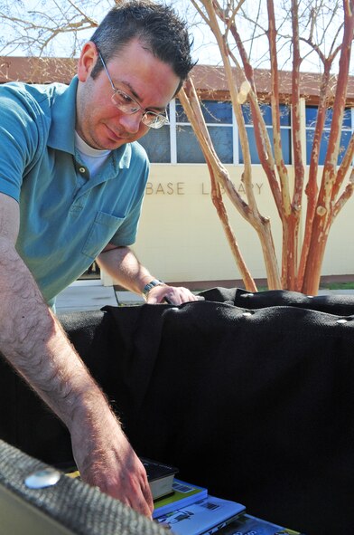Kirk Fontenot, 2nd Force Support Squadron, library systems administrator, collects books from the book return box located outside the Base Library, on Barksdale Air Force Base, La., Feb. 28. The box, which causes less wear-and-tear to circulation items, was recently added to replace an older model. (U.S. Air Force photo/Senior Airman Joanna M. Kresge)(RELEASED)