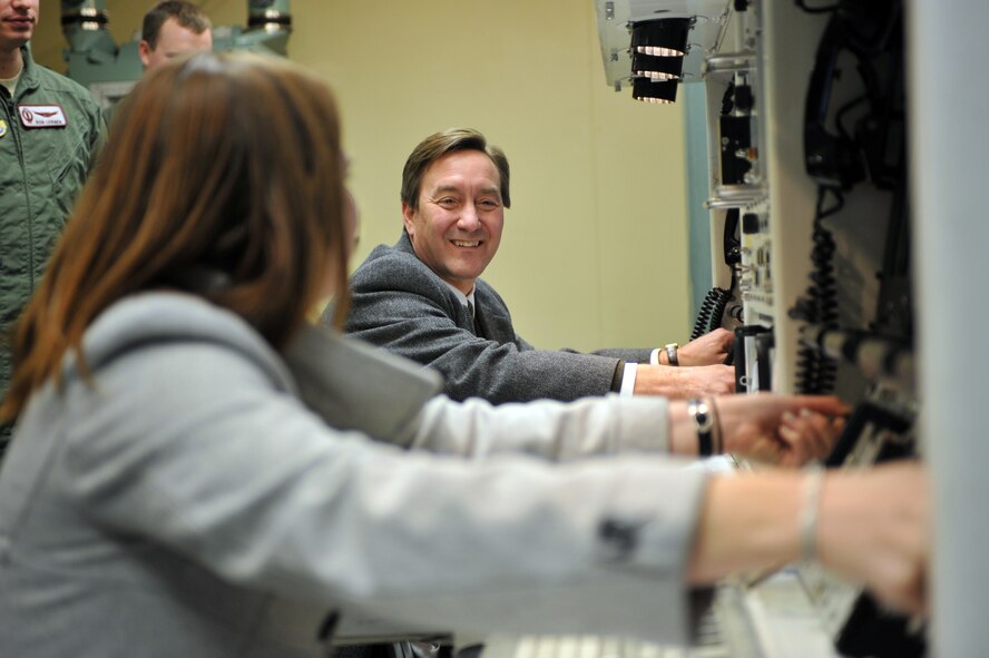 MINOT AIR FORCE BASE, N.D. -- North Dakota Congressman Rick Berg along with his Director of Communications Ms. Alee Lockman, “practice” their key turning technique inside the missile procedures trainer here Feb. 23. This trip marked the congressman’s first visit to Minot to familiarize himself with the base and its mission. (U.S. Air Force photo/Staff Sgt. Keith Ballard)