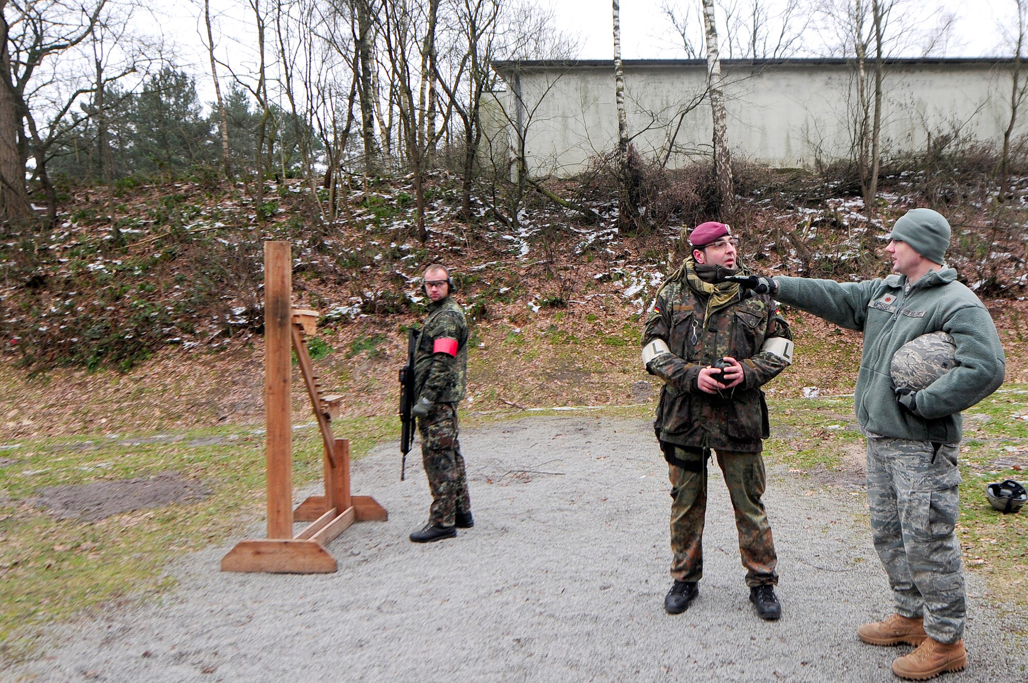 Maj. Jason Medsger receives weapon familiarization training by personnel from the 31st German Airborne Brigade Feb. 18, 2011, in Oldenburg, Germany. Members from the 435th Contingency Response Group attended the German shooting competition, "Schutzenschnur," where they trained and earned a German Shooting Proficiency Badge. Major Medsger is the 435th Security Forces Squadron commander. (U.S. Air Force photo/Airman 1st Class Brea Miller)