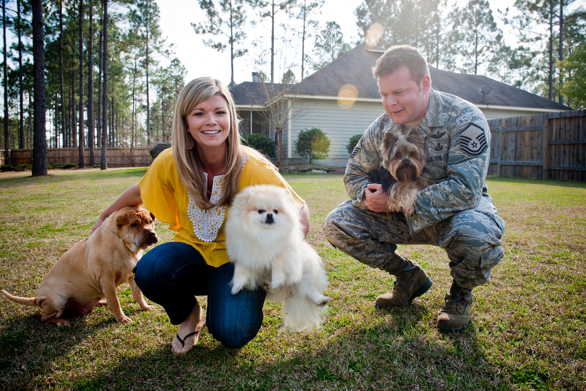 VALDOSTA, Ga. -- Master Sgt. Robert Disney, 347th Rescue Group standards and evaluations superintendent, and his wife, Tess, gather their dogs, Sasha, Minnie and Wall-E, for a photo Feb. 24 at their home. (U.S. Air Force photo/Staff Sgt. Jamal D. Sutter)(RELEASED)