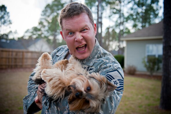 VALDOSTA, Ga. -- Master Sgt. Robert Disney, 347th Rescue Group standards and evaluations superintendent, strikes a pose with his dog, Wall-E, Feb. 24 at his home. Of his three dogs, Wall-E is his favorite because he is the only male. (U.S. Air Force photo/Staff Sgt. Jamal D. Sutter)(RELEASED)