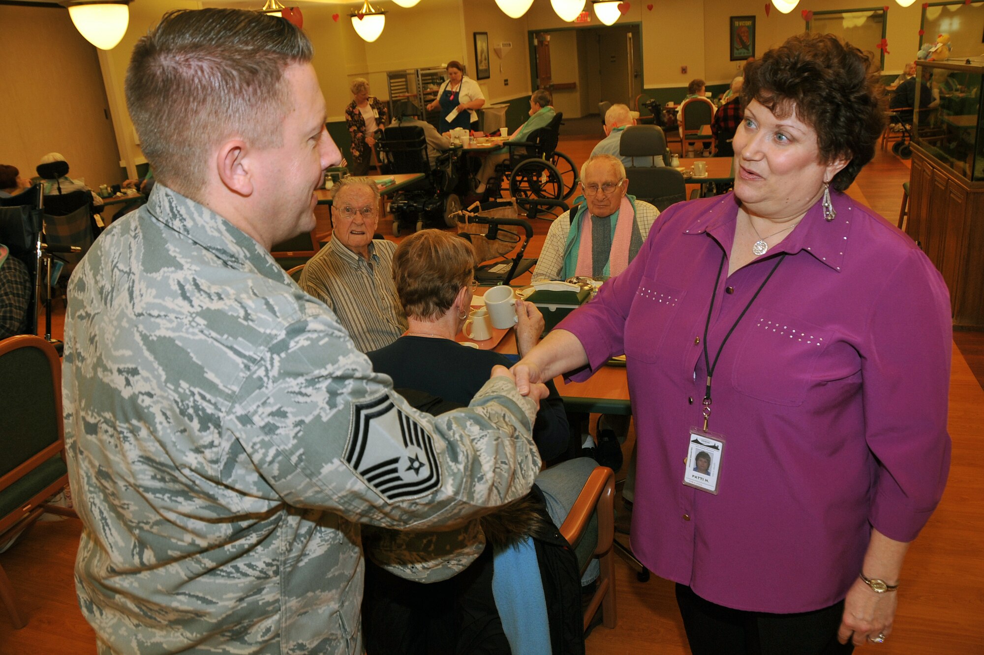 OFFUTT AIR FORCE BASE, Neb. ? Senior Master Sgt. Matthew Becker, 55th Maintenance Squadron, is greeted by Patti Howe, Volunteer Coordinator of the Eastern Nebraska Veterans Home, Feb. 16. Members of the Air Force Sergeant's Association, Chapter 984 make frequent visits to the home in Bellevue. U.S. Air Force Photo by Jeff W. Gates