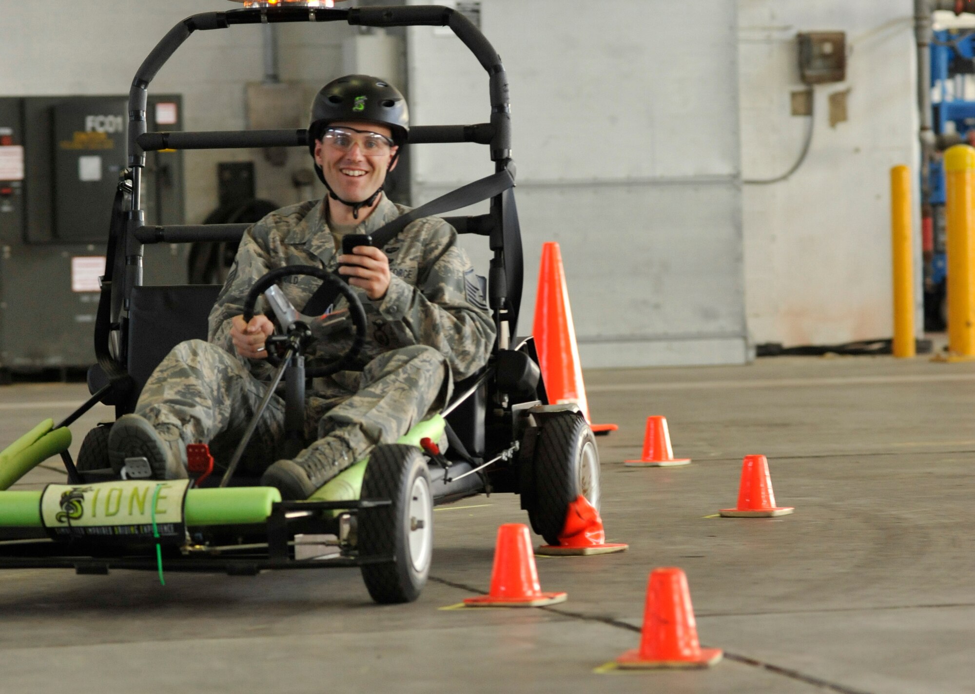 Master Sgt. Christopher Guild, 436th Security Forces Squadron, tries texting while driving a go-kart through a cone course during a community traffic safety program Feb. 25, 2011, at Dover AFB, Del. (U.S. Air Force photo/Airman 1st Class Jacob Morgan)