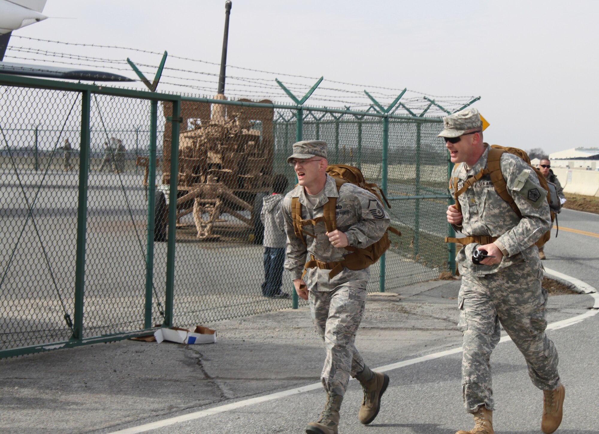 Air Force Master Sgt. Donald Cleveland and Army Ch. (Maj.) Charles Wallace take the last corner on their way to the finish line during the 12th Annual Chosin Reservoir Commemorative Ruck March Feb. 26, 2011. More than 40 teams participated in the Ruck March. There were three teams from Air Force Mortuary Affairs Operations. (U.S. Air Force photo/Christin Michaud)