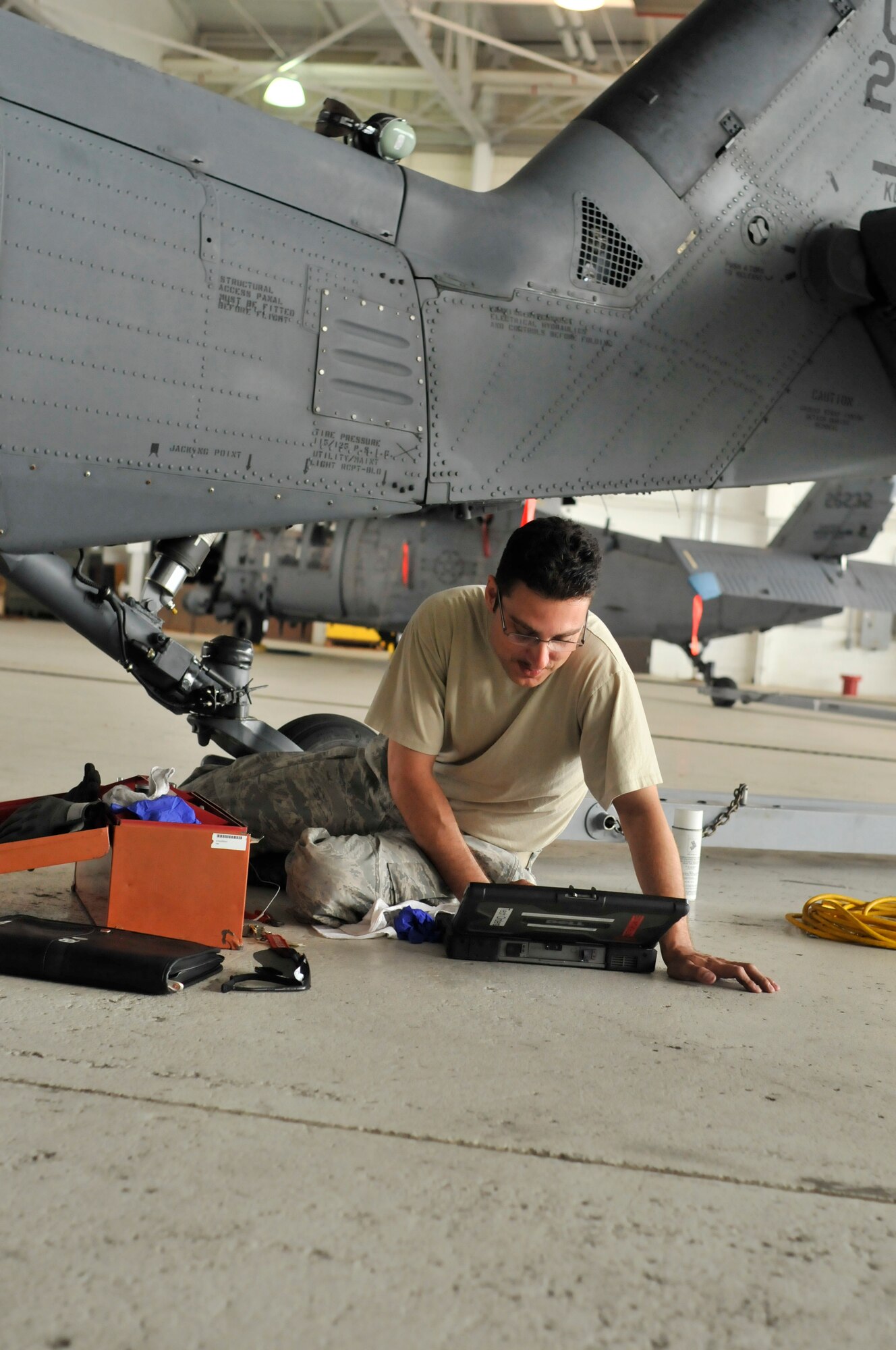 PATRICK AIR FORCE BASE, Fla. - A 920th Rescue Wing maintenance crew chief, Staff Sgt. Jeffery Cope, assigned to the 920th Aircraft Maintenance Squadron here for the HH-60G Pave Hawk helicopters, uses a laptop computer to analyze and repair an H-60 landing-gear problem on this wing chopper. The day prior, Airmen flew the aircraft in support of NASA space shuttle support operations. Maintenance Airmen are on go prior to, and immediately after, space shuttle launches since the Air Force Reservists here are responsible for rescuing the astronauts if they were to bail out of the shuttle due to a Mode VIII emergency, or bailout over the Atlantic Ocean. The reservists are on alert during lift off and until the shuttle returns safely with the astronauts on board. Maintaining the wing's aircraft fleet is vital since all of the 920th's assets are utilized for NASA support during launches. (U.S. Air Force photo/Capt. Cathleen Snow)