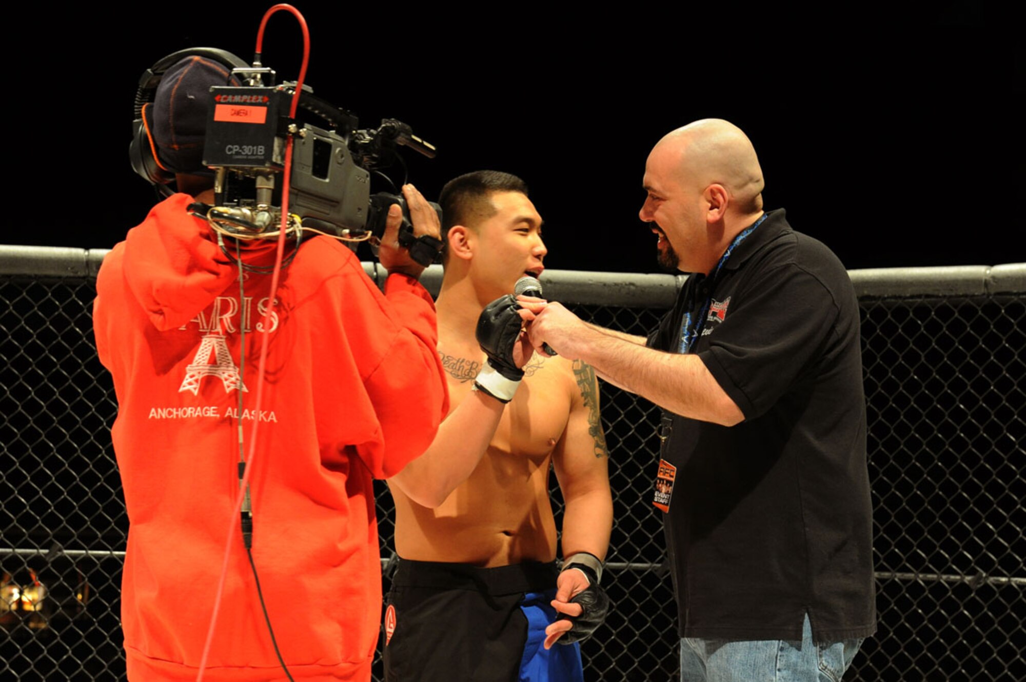 ANCHORAGE , Alaska -- Airman 1st Class Nojin “Ian” Park, 3rd Maintenance Operation Squadron, does a post fight interview with Alaska Fighting Championship announcer after winning his debut Mixed Martial Arts fight at the Anchorage Sullivan Arena, February 17. Park won the fight in forty-four seconds of the first round by technical knockout. (U.S. Air Force Photo by Staff Sgt. Joshua Garcia)