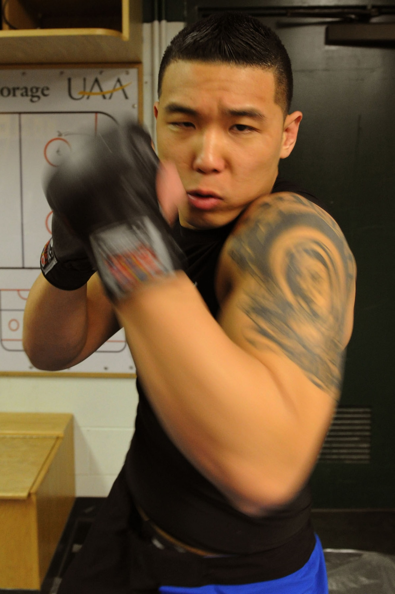 ANCHORAGE , Alaska -- Airman 1st Class Nojin “Ian” Park, 3rd Maintenance Operation Squadron, practices punching combinations prior to his first Mixed Martial Arts fight at the Anchorage Sullivan Arena, February 17. Prior to fights most fighters will warm up going over simple techniques to stay warm and keep their minds in the fight. (U.S. Air Force Photo by Staff Sgt. Joshua Garcia)