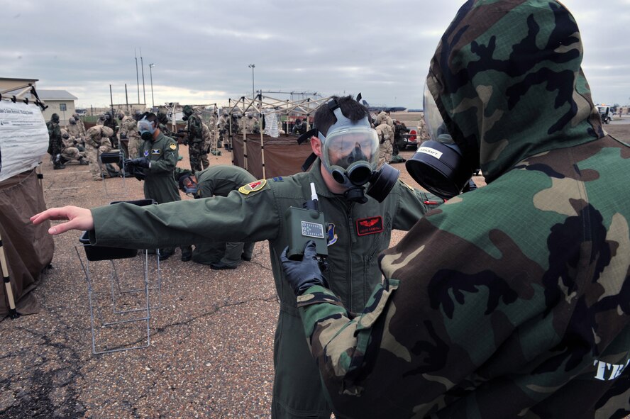 Senior Airman Brandon Ashcraft, 2nd Civil Engineer Squadron, uses a joint chemical agent detector to inspect Capt. Jacob Randal, 96th Bomb Squadron, during the Ability to Survive and Operate Rodeo during the Conventional Operational Readiness Exercise on Barksdale Air Force Base, La., Feb. 25. The JCAD is used to detect, identify, quantify, alert and report the presence of chemical warfare agents and toxic industrial chemical vapor.  (U.S. Air Force photo/Airman 1st Class Micaiah Anthony)(RELEASED)