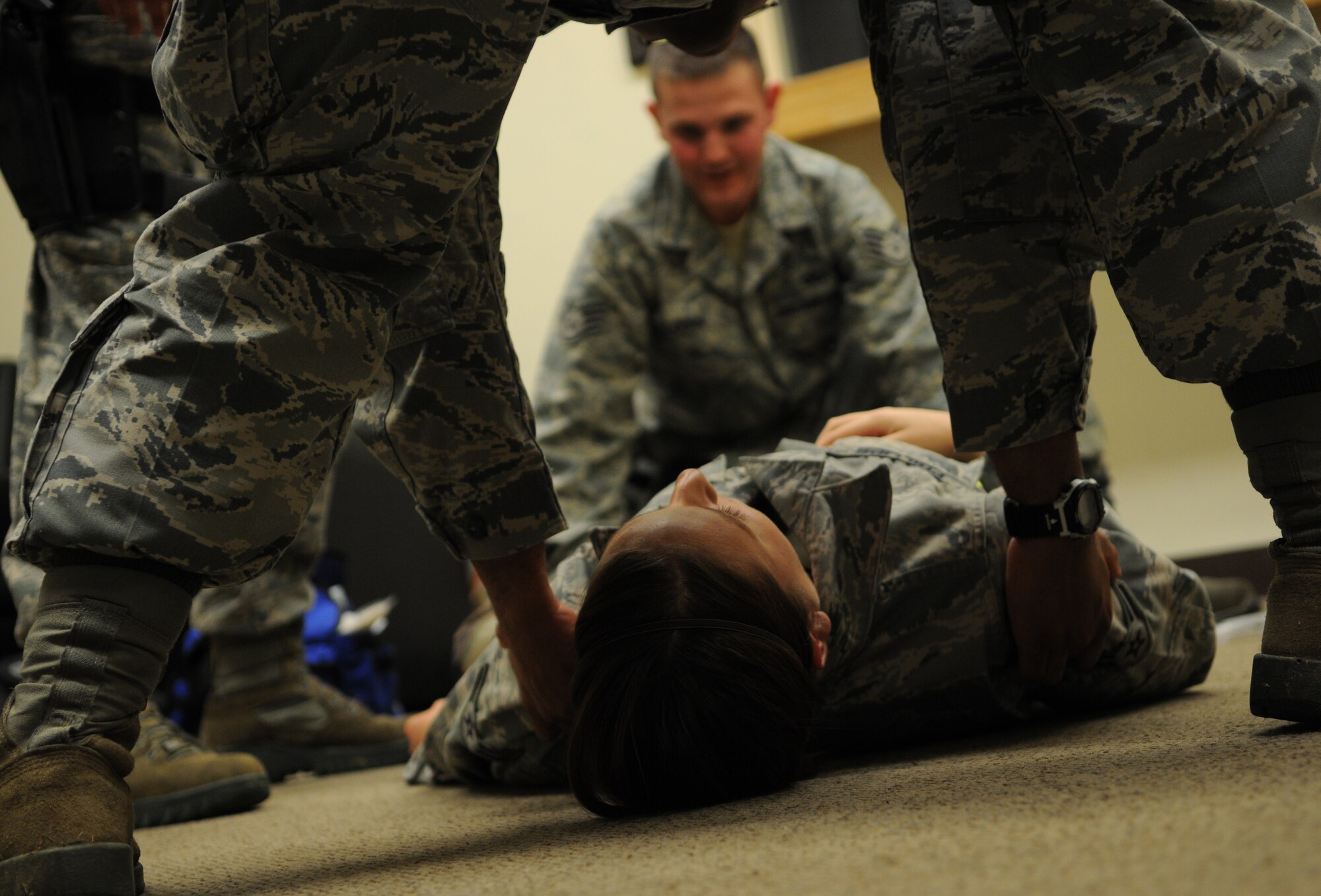 Members of the 18th Security Forces Squadron, act as first responders to a simulated "hit and run" victim during Beverly High 11-03, a local operational readiness exercise at Kadena Air Base, Japan, March 1, 2011. Kadena service members participate in exercises to prepare for real-world contingencies. (Air Force photo/Airman 1st Class Jarvie Z. Wallace)