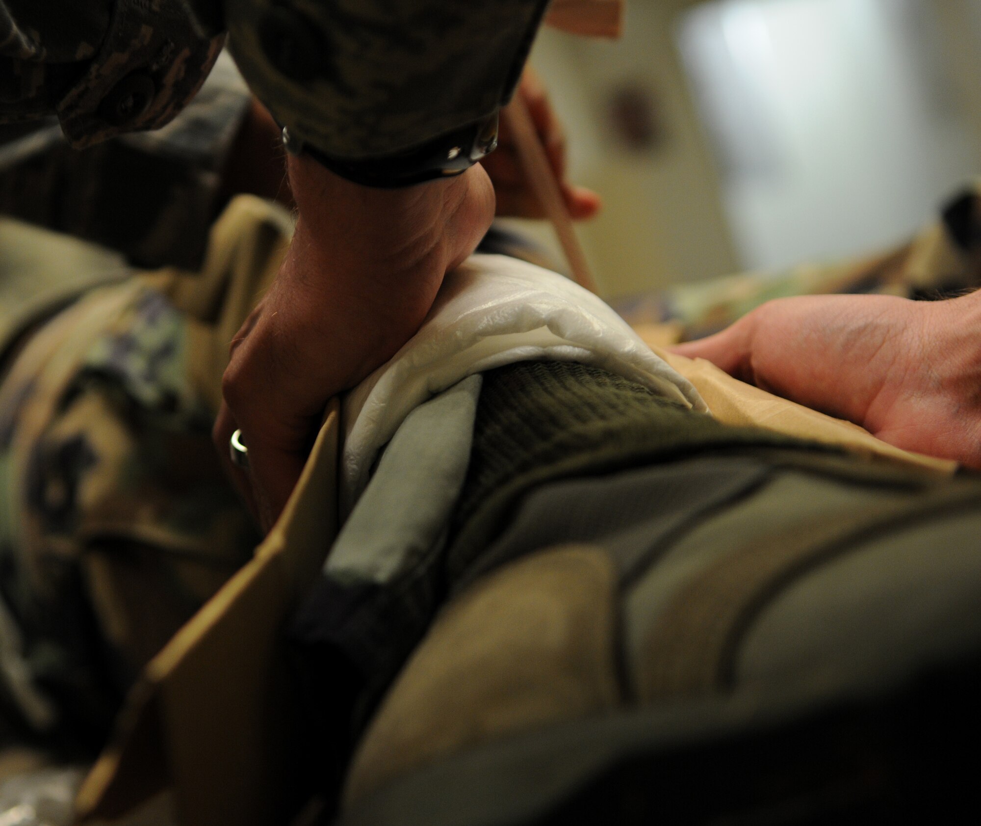members from the 18th Security Forces Squadron, apply a splint to a leg of a simulated 'hit and run' victim during Beverly High 11-03, a local operational readiness exercise at Kadena Air Base, Mar. 1. Kadena's members use exercises to prepare for potentially real-world emergencies. (Air Force photo/Airman 1st. Class Jarvie Z. Wallace.)