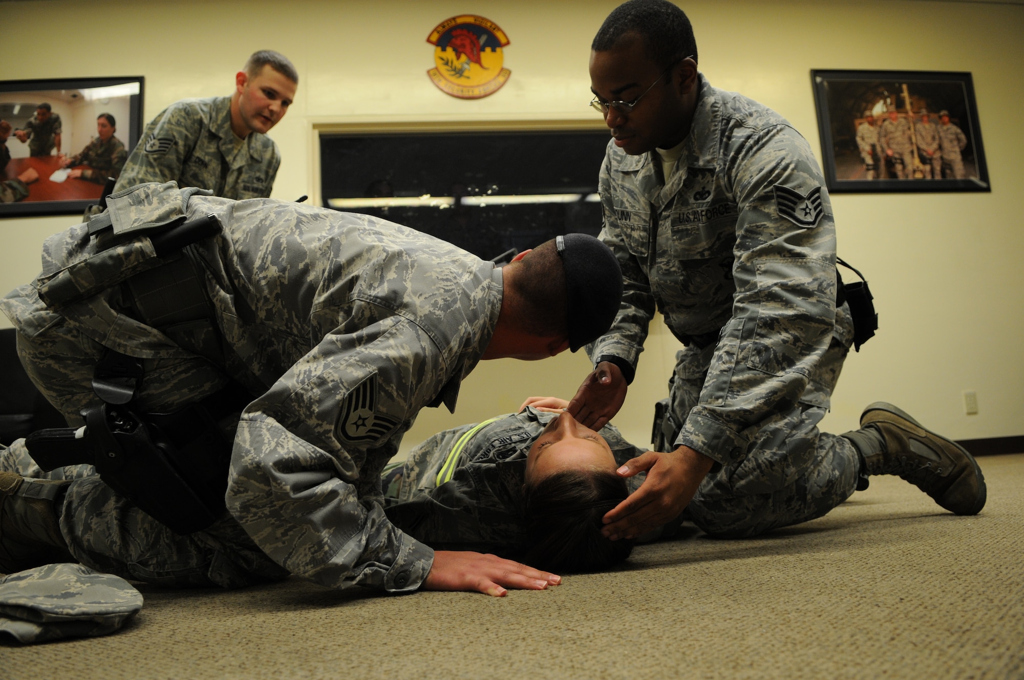 Members from the 18th Security Forces Squadron, act as first responders to a simulated 'hit and run' victim during Beverly High 11-03, a local operational readiness exercise at Kadena Air Base, Japan, Mar. 1, 2011. Kadena's members participate in exercises to prepare for potentially real-world emergencies. (Air Force photo/Airman 1st. Class Jarvie Z. Wallace)