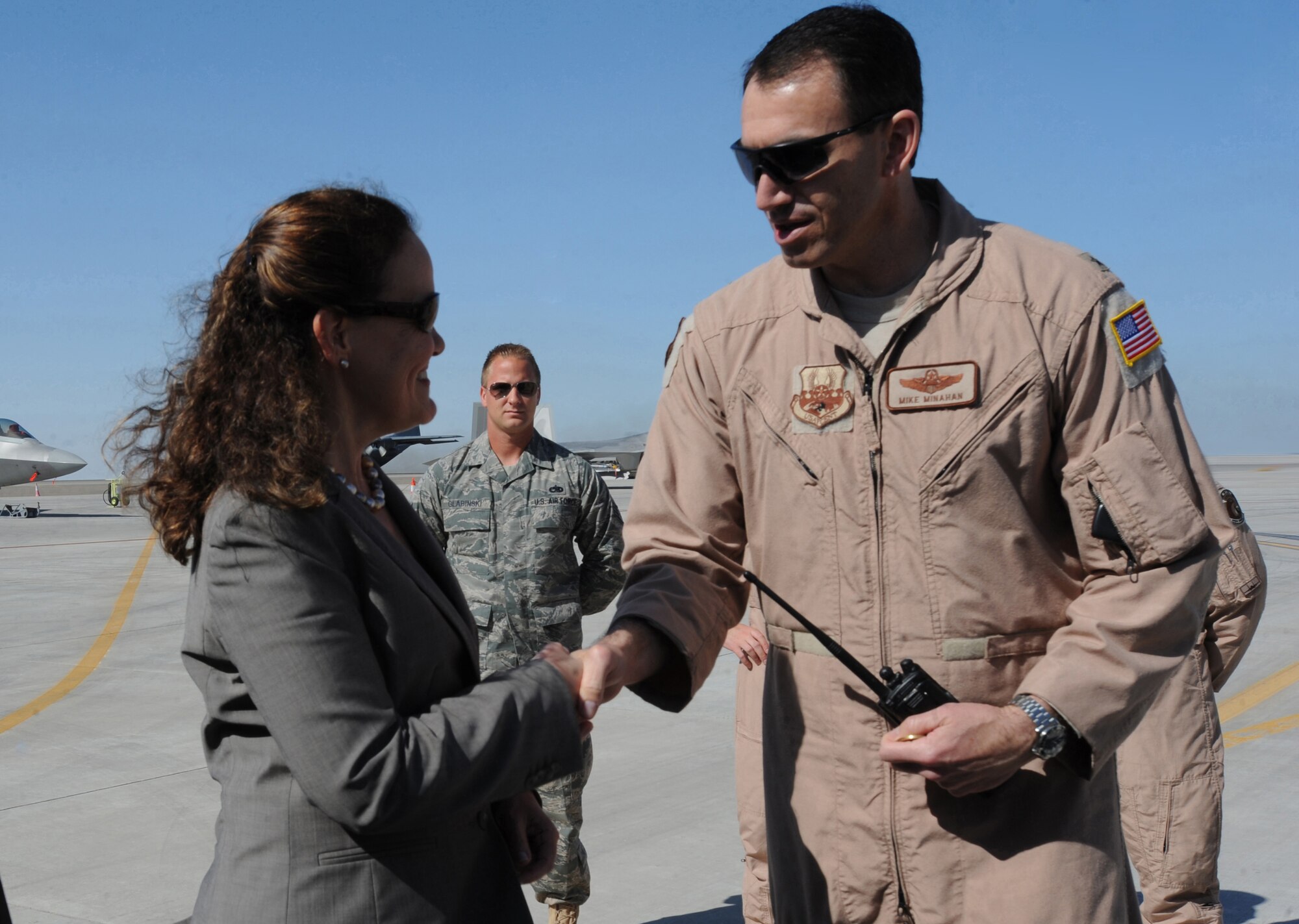 Under Secretary of Defense for Policy Michele Flournoy, receives a coin from Brig. Gen. Mike Minahan, 380th Air Expeditionary Wing commander, in Southwest Asia on Feb. 4, 2011. Ms. Flournoy visited the AOR for a base tour. (U.S. Air Force photo by Senior Airman Maynelinne De La Cruz)