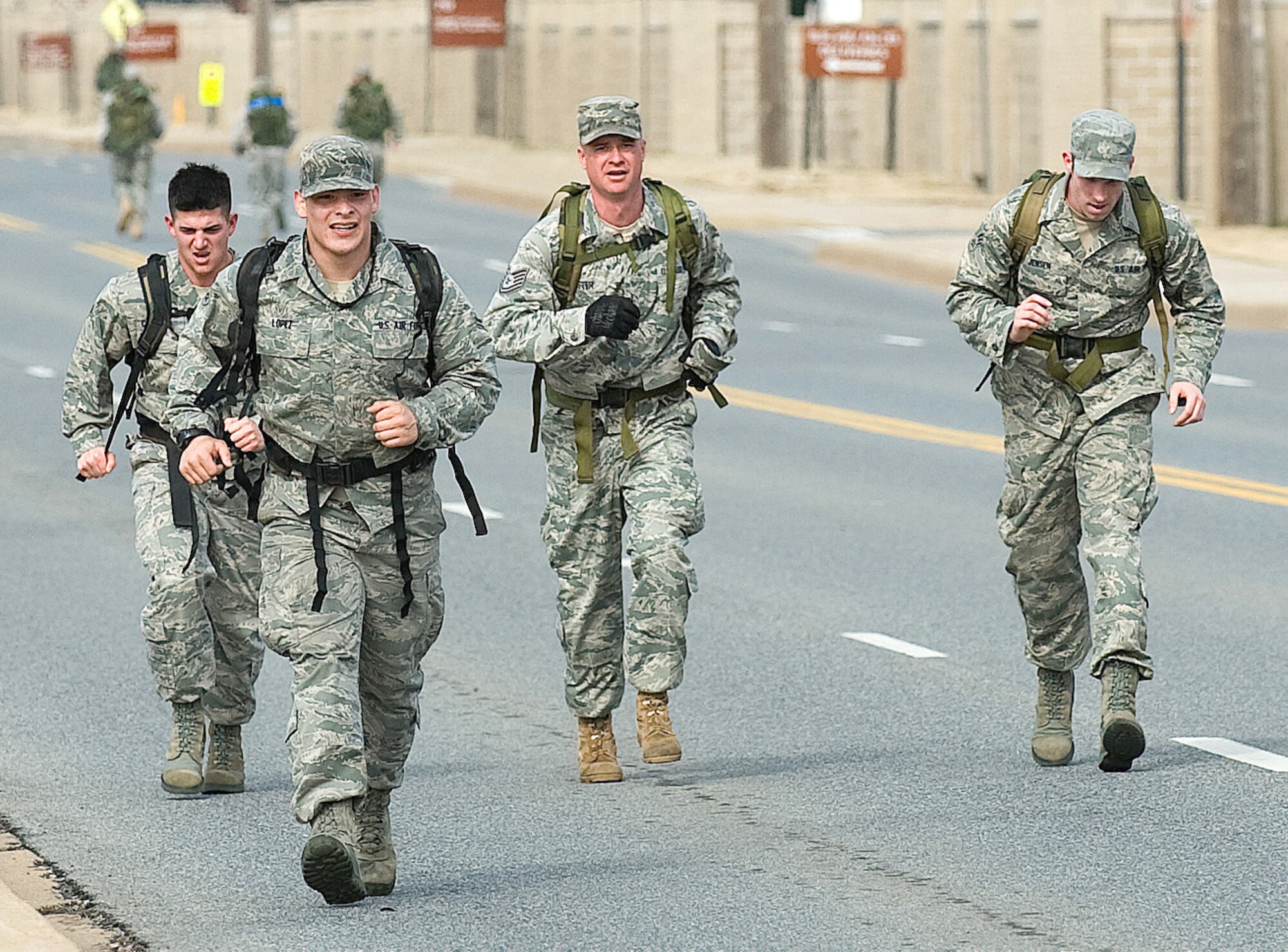 Tech. Sgt. Paul Schuster, 436th Aerial Port Squadron air transportation supervisor,  and Airman 1st Class Dustin Carlton, Airman 1st Class Marcus Lopez and Senior Airman Ethan Jensen, all 436th APS air transportation specialists, race towards the finish line, Feb. 26, 2011, during the 12th Annual Ruck March on Dover Air Force Base, Del. The team placed first in the event with a time of 1 hour, 4 minutes, 45 seconds.