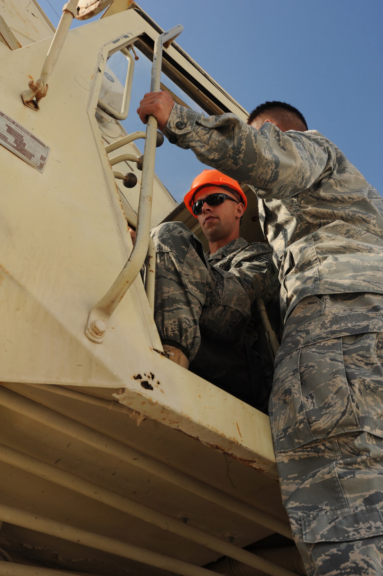 Senior Airman Steven Chalupnik, 380th Expeditionary Civil Engineer Squadron, uses a 60-ton crane to move cooling units and generators Feb 8, 2011 in Southwest Asia. Moving the generators makes way for some new tents. (U.S. Air Force photo by Senior Airman Maynelinne De La Cruz) 