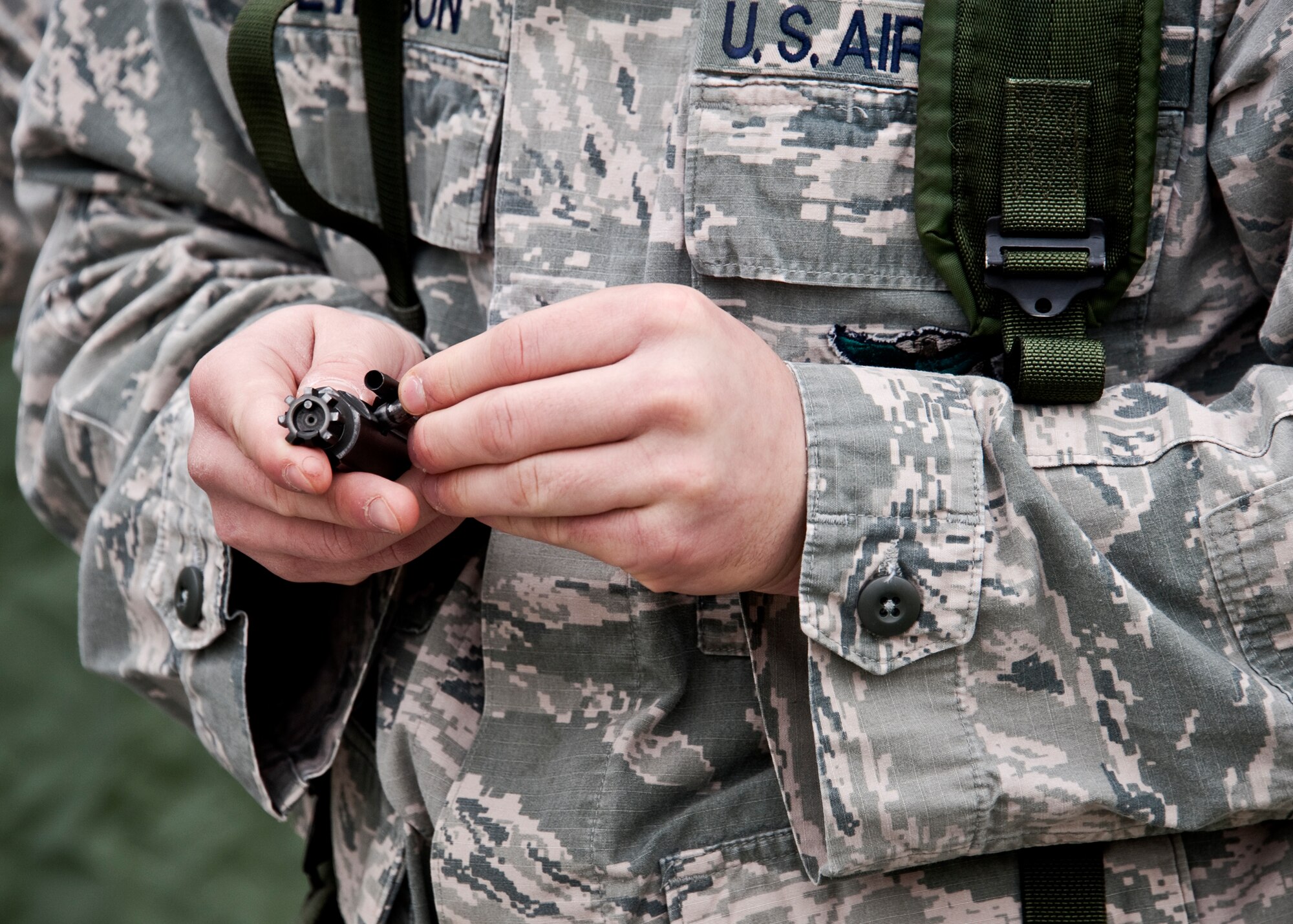 An Airman breaks down the bolt carrier of his M-16 during the during the Phase II exercise Feb. 24 at Eglin Air Force Base, Fla.  Phase II included self-aid and buddy care, weapons, and chemical, biological, radiological, nuclear and explosive training.  Airmen learned the proper procedures for self-aid and buddy care, field stripping a weapon and also how to wear and work in their chemical gear and gas masks.  Three chalks of Eglin Airmen participated in Phase I and II exercises as part of an Operational Readiness Exercise throughout the week of Feb. 22-25.  (U.S. Air Force photo/Samuel King Jr.)