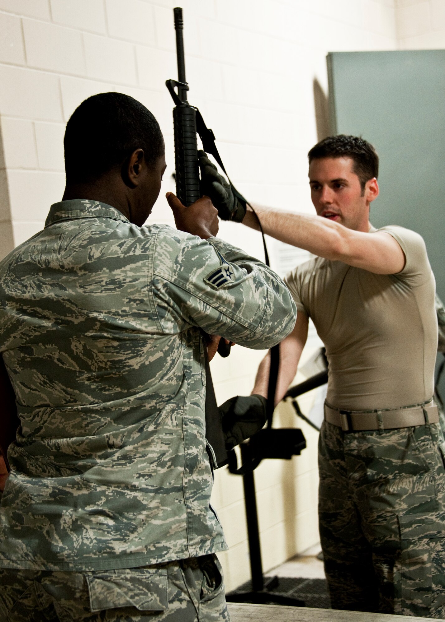 Senior Airman Marcus Prince, 96th Aerospace Medicine Squadron, receives his weapon from Staff Sgt. Andrew Curtis, 96th Logistics Readiness Squadron, as part of the Phase I exercise Feb. 23 at Eglin Air Force Base, Fla.  Phase I included deployment preparation, records review, mobility gear and weapon issue.  Three chalks of Eglin Airmen participated in Phase I and II exercises as part of an Operational Readiness Exercise throughout the week of Feb. 22-25.  (U.S. Air Force photo/Samuel King Jr.)