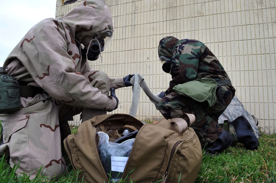 Airmen provide self aid and buddy care during the Ability to Survive and Operate Rodeo as part of a Conventional Operational Readiness Exercise at Barksdale Air Force Base, La., Feb. 25. The ATSO Rodeo emphasized contamination control, unexploded ordnance identification, SABC and marking and asset protection in a chemical environment. (U.S. Air Force photo/Senior Airman Brittany Y. Bateman)(RELEASED)