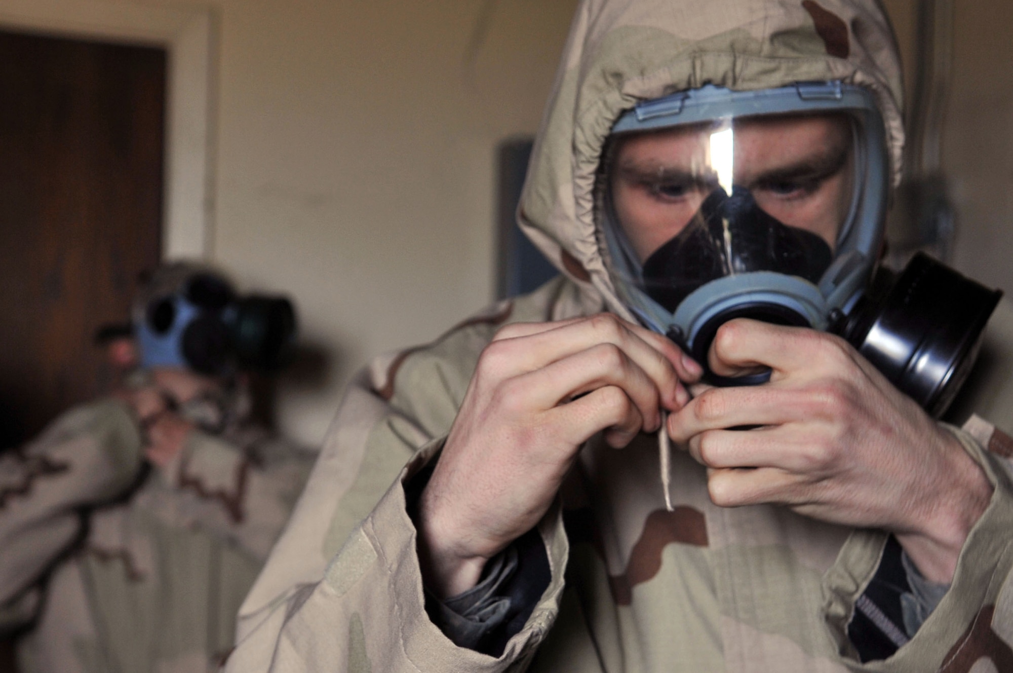 Airmen don their gas masks when alarm red sounds during the Ability to Survive and Operate Rodeo during a Conventional Operational Readiness Exercise at Barksdale Air Force Base, La., Feb. 25. ATSO Rodeo tested the knowledge and skill of Airmen to respond to chemical attacks. (U.S. Air Force photo/Senior Airman Brittany Y. Bateman)(RELEASED)