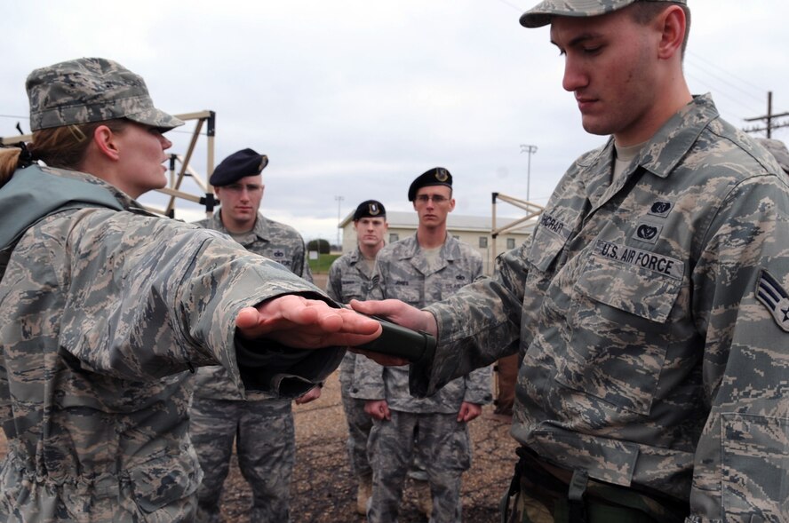 Staff Sgt. Elyce Holloway and Senior Airman Brandon Ashcraft, 2nd Civil Engineer Squadron emergency management, demonstrate how to use a joint chemical agent detector during the Ability to Survive and Operate Rodeo during a Conventional Operational Readiness Exercise at Barksdale Air Force Base, La., Feb. 25. The JCAD is used to detect, identify, quantify, alert and report the presence of chemical warfare agent and toxic industrial chemical vapor. (U.S. Air Force photo/Senior Airman Brittany Y. Bateman)(RELEASED)