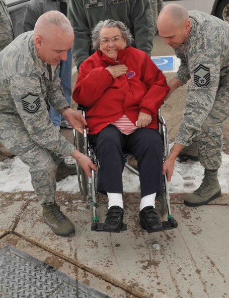 Master Sgt. Mark Stodola, 934th Security Forces Squadron (left), and Senior Master Sgt. Doug Johnson, 934th Civil Engineer Squadron, assist veterans from the Minnesota Veterans Home as they arrive at the "Take a vet to lunch day" Feb. 24. (Photo by Paul Zadach)