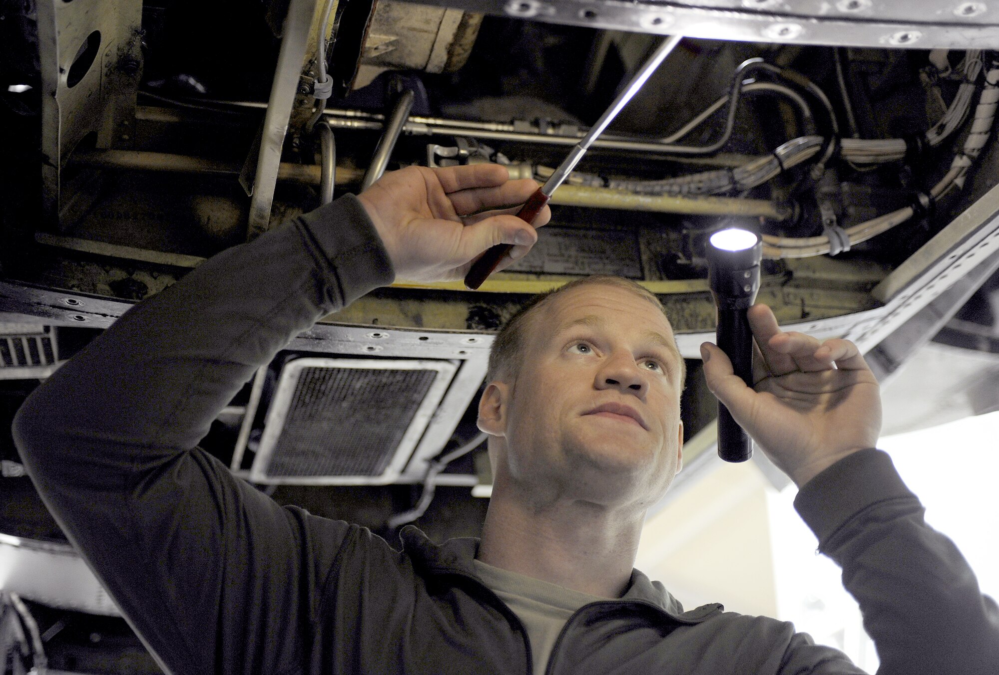 Senior Airman Austin Strabala inspects the environmental control system compartment for foreign objects prior to a quality assurance inspection Feb. 22, 2011, at Kandahar Airfield, Afghanistan. Airman Strabala is an A-10 Thunderbolt II phase inspection section journeyman assigned to the 451st Expeditionary Maintenance Squadron. (U.S. Air Force photo/Senior Airman Willard E. Grande II) 