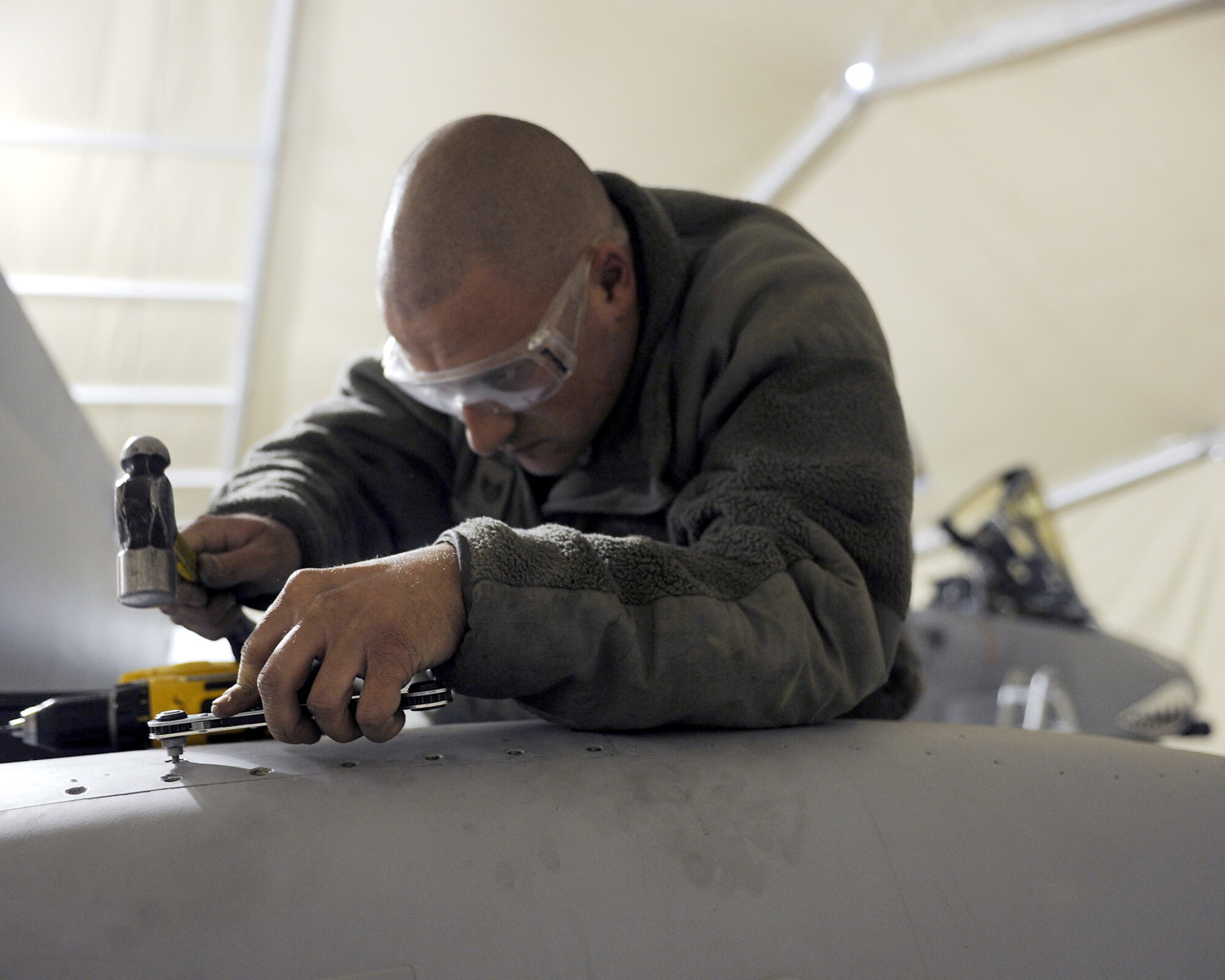 Staff Sgt. Jonathan Shipp removes stuck screws from an access panel on an A-10 Thunderbolt II during a phase inspection Feb. 22, 2011, at Kandahar Airfield, Afghanistan. The 451st Air Expeditionary Wing's Expeditionary Maintenance Squadron conducts a phase inspection every 500 flight hours. Sergeant Shipp is an aircraft structural maintenance craftsman assigned to the 451st EMXS. (U.S. Air Force photo/Senior Airman Willard E. Grande II) 